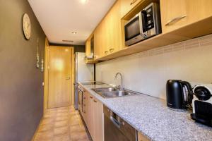 a kitchen with a sink and a microwave at Ground floor apartment in Centre of Torroella De Montgri in Torroella de Montgrí
