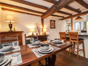 a kitchen and dining room with a wooden table at Tudor Cottage in Sandwich