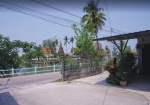 a building with a view of a river and a bridge at YaiJaew House in Sukhothai