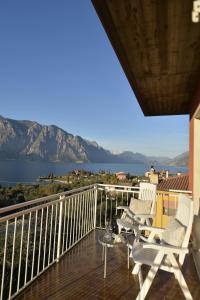 a balcony with chairs and a view of the water at Hotel Villa Florida in Malcesine