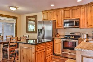 a kitchen with wooden cabinets and a stainless steel refrigerator at Lost Lake Lodge in Nisswa