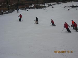 a group of people skiing down a snow covered slope at Den Hagen Guest Farm in Rhodes