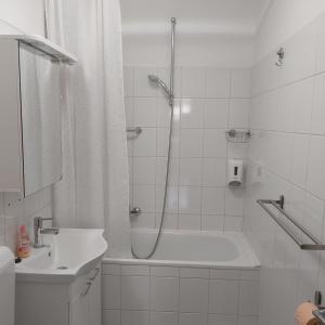 a bathroom with a shower and a tub and a sink at BP APARTMAN in Poreč