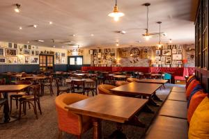 a restaurant with tables and chairs in a room at Spindrift in Rendham