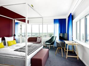 a hotel room with a bed and a desk at Comwell Aarhus Dolce by Wyndham in Aarhus