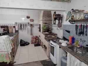 eine Küche mit Spüle und Arbeitsplatte in der Unterkunft GUARUJÁ ENSEADA CASA 6 PES PROX PRAIA in Guarujá + 9 Fotos