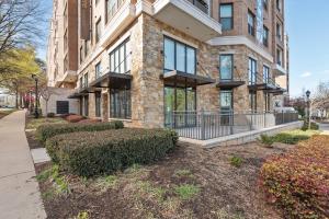 a large brick building with bushes in front of it at Kasa Dilworth Charlotte in Charlotte