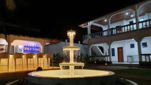 a fountain in front of a building at night at Pawikan Boutique Hotel in Moalboal