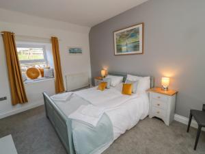 a bedroom with a large bed and a window at Woolley Lodge in Wooler