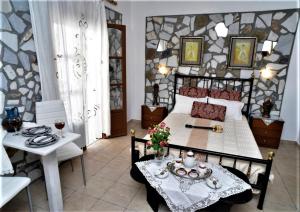 a bedroom with a bed and a table and chairs at Pasas Castle - Unique Luxury Apartments in Naxos Chora