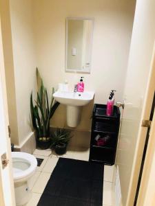 a bathroom with a sink and a toilet and a mirror at Bay View Apartment Sunvida Tower 28 in Cebu City