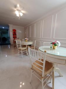a dining room with two tables and chairs at Hotel Kasvel in Valledupar