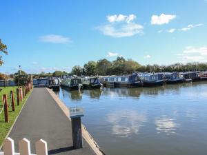 a bunch of boats are docked in a river at The Swift in Whitchurch