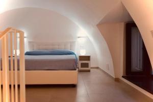 a bedroom with a bed and a staircase in an attic at Zaras in Ischia