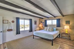 a bedroom with a bed and a window at Pet-Friendly Home with Patios and Private Hot Tub! in Twentynine Palms +29 photos