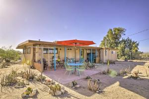 a house in the desert with a table and chairs at Pet-Friendly Home with Patios and Private Hot Tub! in Twentynine Palms