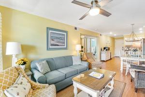 a living room with a blue couch and a table at Oceanside 306-B in Isle of Palms