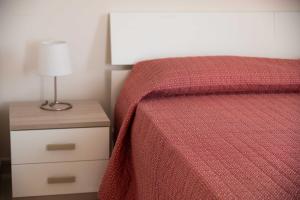 A bed or beds in a room at B&B Il Nido sui Trulli