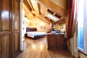 a bedroom with a bed and a desk in a room at Locanda San Paolo in Monza