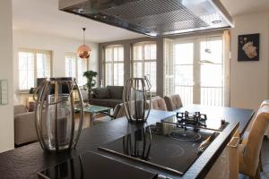 una cocina con una mesa con dos jarrones de cristal. en Appartement Volendam en Volendam