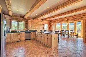 a large kitchen with wooden cabinets and a dining room at Hot Tub, Game Room and Theater Luxe Show Low Home in Show Low