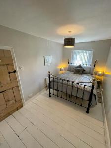 a bedroom with a bed and a window and a door at Number 8 Clandown in Radstock