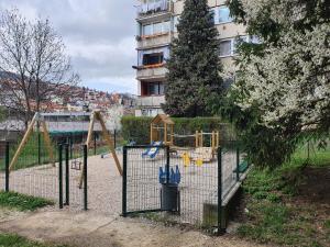 a playground in front of a building at Kosevo Apartment in Sarajevo