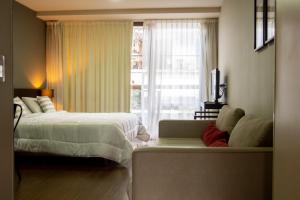 ブエノスアイレスにあるAyres Apartments Palermoのベッドとソファと窓のある寝室 +53枚の写真