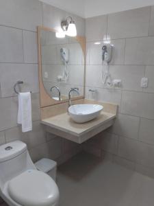 a bathroom with a toilet and a sink and a mirror at CoralK Apartments Sosúa in Sosúa +23 photos