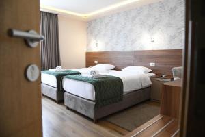 Postel nebo postele na pokoji v ubytování Hotel Garden