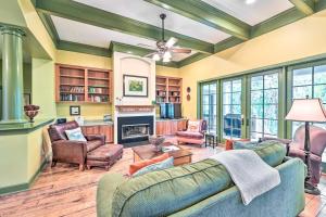 a living room with couches and a fireplace at Chic Bluffton Cottage with Yard, 7 Mi to Beach! in Bluffton