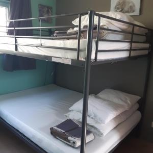 a couple of bunk beds with a suitcase on them at Terrasses de Malmedy - Duplex 455 in Malmedy