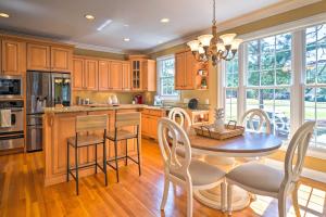 a kitchen with wooden cabinets and a table and chairs at Golfers Dream Near Clubhouse of PCC No 6! in Pinehurst