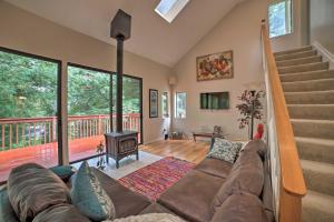 a living room with a couch and a fireplace at Tree-Lined Los Gatos Home with Spacious Deck! in Los Gatos