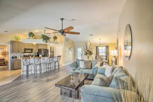 a living room with a couch and a table at Stunning Cape Coral Getaway with Lanai and Heated Pool in Cape Coral