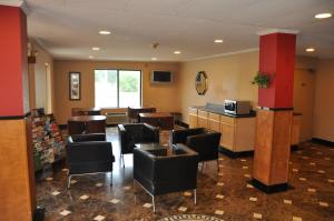 a waiting room with black chairs and a counter at Heritage Inn in Beaumont