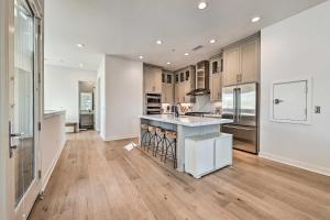 a kitchen with a island in the middle of a room at Luxe Retreat with Rooftop Less Than Half Mi to Beach! in Dana Point