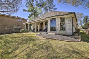 a house with a large window on a yard at Grills and Boat Dock Comfy Cove on Lake Conroe in Montgomery