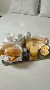 a tray with sandwiches and other food on a bed at Hotel La Costa - Adults Only in Rio de Janeiro