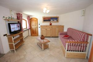 a living room with a couch and a tv at Bellevue in Aosta