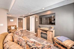 a living room with a couch and a flat screen tv at Beautiful and Updated Apartment in Heber City! in Heber City