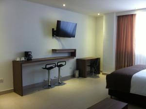 Ένα ή περισσότερα κρεβάτια σε δωμάτιο στο Hausen Hotel - Suites