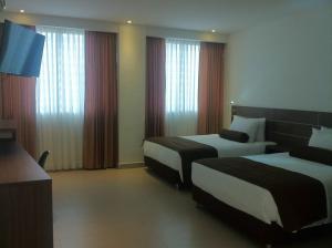 Ένα ή περισσότερα κρεβάτια σε δωμάτιο στο Hausen Hotel - Suites