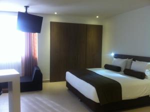 Ένα ή περισσότερα κρεβάτια σε δωμάτιο στο Hausen Hotel - Suites