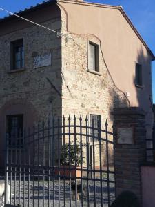 a building with a fence in front of it at L'Aia degli olivi in Vada