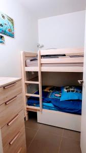 a bedroom with two bunk beds and a desk at appartement résidence La Plage 4 **** in La Londe-les-Maures