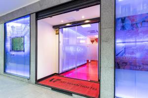 a glass door of a building with a sign in it at Art Seven Hostel Capsules in Madrid