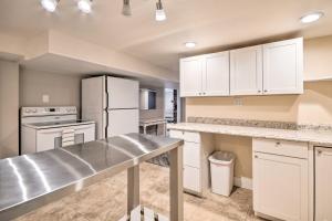 a kitchen with white cabinets and a counter top at Renovated Apartment about 7 Mi to Dtwn Billings in Billings