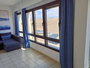 a room with a chair and a window with a view at Apartamento (Cotillo Mar) con vistas al Mar in El Cotillo