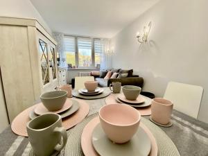 a living room with a table with cups and saucers at Kryształowy apartament in Tarnowskie Góry